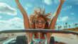 Joyful woman with raised arms in convertible car.