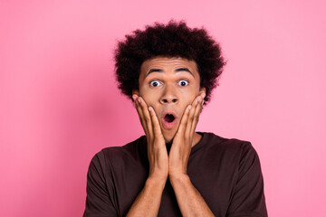 Wall Mural - Closeup photo of young shocked wavy hair man touch cheeks amazed unbelievable moment in his life isolated on pink color background