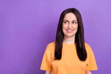 Sticker - Photo of pleasant woman with straight hairstyle dressed orange t-shirt look at offer empty space isolated on purple color background