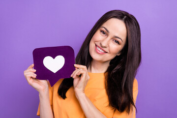 Sticker - Photo of nice cheerful woman with straight hairstyle dressed orange t-shirt demonstrate heart icon isolated on purple color background