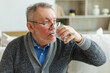 © Юлия Завалишина - Senior man holding glass drinking fresh water at home. Mature old senior thirsty grandfather takes care of his health. Healthcare water balance. Elderly healthy lifestyle