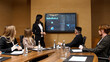 © Vladislav - Business meeting in the conference room. A businesswoman is talking to her colleagues while an animated chart data is displayed on the computer screen.