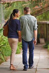 Poster - Couple, holding hands and love or together in garden, relationship and care on outdoor adventure or holiday. People, back and walking on vacation and romance in park or zoo, date and calm or peace