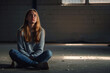 Teenager girl with depression sitting alone on the floor in the dark room