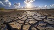 A drought-stricken landscape, with cracked earth and a dried-up riverbed under a scorching sun.