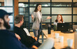 © Jacob Lund - Successful project discussion: Young business woman leads a creative brainstorm for a new project