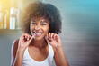 © Mapodile M/peopleimages.com - African woman, dental floss and smile in bathroom for oral wellness, health and benefits for mouth in portrait. Girl, person and teeth whitening with string, cleaning and change for results in house