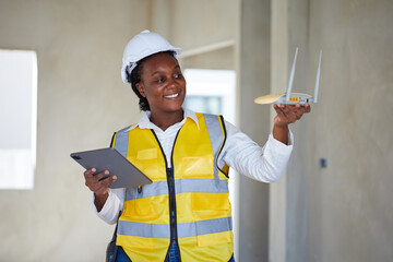 worker or technician holding and checking wifi router for install cable internet at construction site