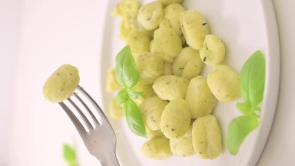 Wall Mural - Italian gnocchi. Traditional Italian food. Handmade potato balls with parmesan and basil. Food for vegetarians and lovers of Italian typical cuisine. homemade pasta . Vertical video