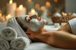 Portrait of a woman at spa treatments at a cosmetologist in beauty salon - lying with a cosmetic mask on her face, with creme, lotion and oil