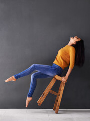 Wall Mural - Woman, chair and fashion for style, trendy and laugh for smile and apparel in clothes and excited. Female person, excited and lean on stool for wardrobe, confident and elegant beauty and mockup