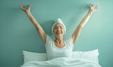 Fototapeta Góry - Senior woman on hospital bed celebrating her recovery from surgery or beating cancer
