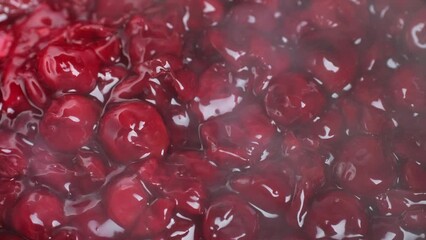 Wall Mural - Zoom frame boiling in pan cherries with sugar for make cherry jam or other dessert