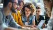 © Kateryna - An energetic team of web developers surrounding a businesswoman, who is demonstrating a new feature on her laptop, with copy space