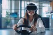 © pawimon - A happy Women in Virtual Reality Glasses sits at a table and controls a virtual machine