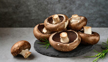 Raw Fresh Portabella Mushrooms On A Slate Board.