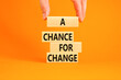 A chance for change symbol. Concept words A chance for change on beautiful wooden block. Beautiful orange table orange background. Voter hand. Business A chance for change concept. Copy space.