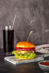 Wall Mural - Food photography of hamburger, cheese, sandwich, beef, bun, lettuce, tomato, onion, soda, drink, cola, background, hungry, american, restaurant, snack, meal