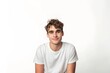 © Nico - A young man is smiling and wearing a white shirt. He is sitting on a white background. Concept of happiness and positivity