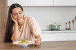 © Pixel-Shot - Young woman with tasty pasta in kitchen