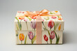 Gift box with watercolor tulips on it. Gift adorned with a ribbon. Perfect for Woman's Day, Mother’s Day, birthday card.
