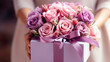 Close up of box with pink and light violet roses in female hands. Happy Mother's Day or Happy Women's day, birthday card.