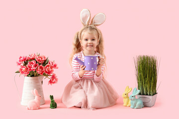 Sticker - Cute little girl in bunny ears with tulip flowers, grass and toy rabbits on pink background. Easter celebration