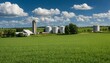 Farm scene with blue sky, lush green meadows, a farmhouse, and a silo, depicting rural agriculture