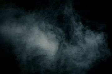 Wall Mural - White steam on a black background.