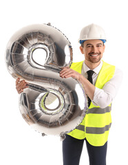 Poster - Happy young male architect with balloon in shape of figure 8 isolated on white background. International Women's Day