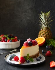 Poster - Tasty slice of cheesecake with fresh fruits and berries on the table