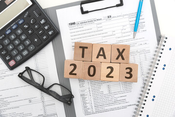 Wall Mural - A wooden block with the word tax 2023