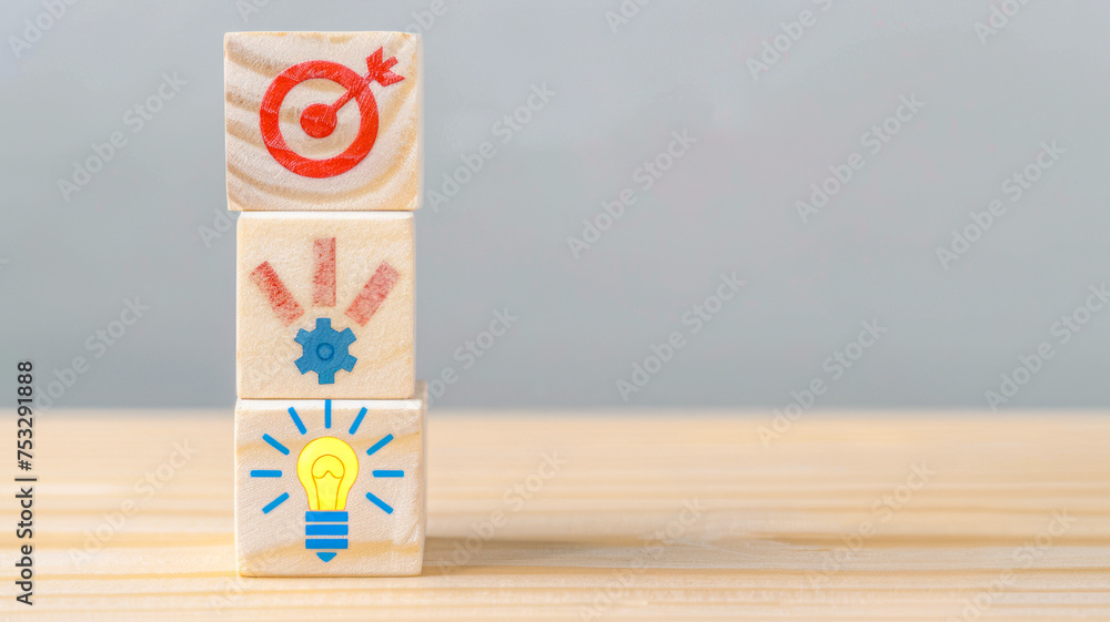 Wooden blocks with target, gears, and light bulb icons represent goal ...