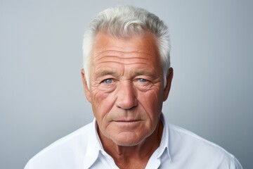 Wall Mural - Portrait of a senior man with grey hair and blue eyes.