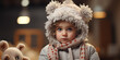 Portrait of a cute little girl in a winter hat and scarf