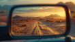 Rearview mirror showing a desert road at sunset.