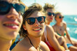 Group of young people having fun. Wearing black sunglasses, while sitting on a boat and relaxing in summer time by the sea or ocean