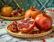 Whole and Cut Orange and Red Pomegranates on a Wooden Platter on a Quartz Kitchen Countertop
