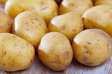 Wall Mural - Fresh ripe potatoes on wooden table. Healthy nutrition concept..