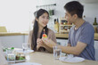 © DG PhotoStock - Man surprise girlfriend with a cake.