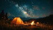 © wpw - Enjoy the serene ambiance of a campfire and tent under a starry night sky.
