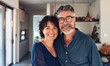 © Olena Rudo - Mature Couple Embracing in a Cozy Home Kitchen During Daytime