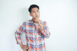 Adult Asian man wearing flannel shirt showing thinking gesture