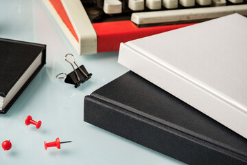 Sticker - Hardcover book and vintage typewriter on white desk