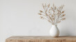 Modern white ceramic vase with dry grass on wooden table, generative Ai
