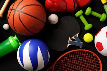 Wall Mural - Various sports equipment on black background studio shot