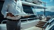 © kamonrat - exceptional service Inside a luxury yacht,Waiter holding empty silver tray
