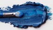 A brush smears the blue paint
