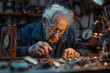 An elderly ccarved a tropy  at work in a workshop
