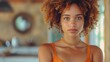 © Neural Pixels - A woman with curly hair is wearing an orange tank top